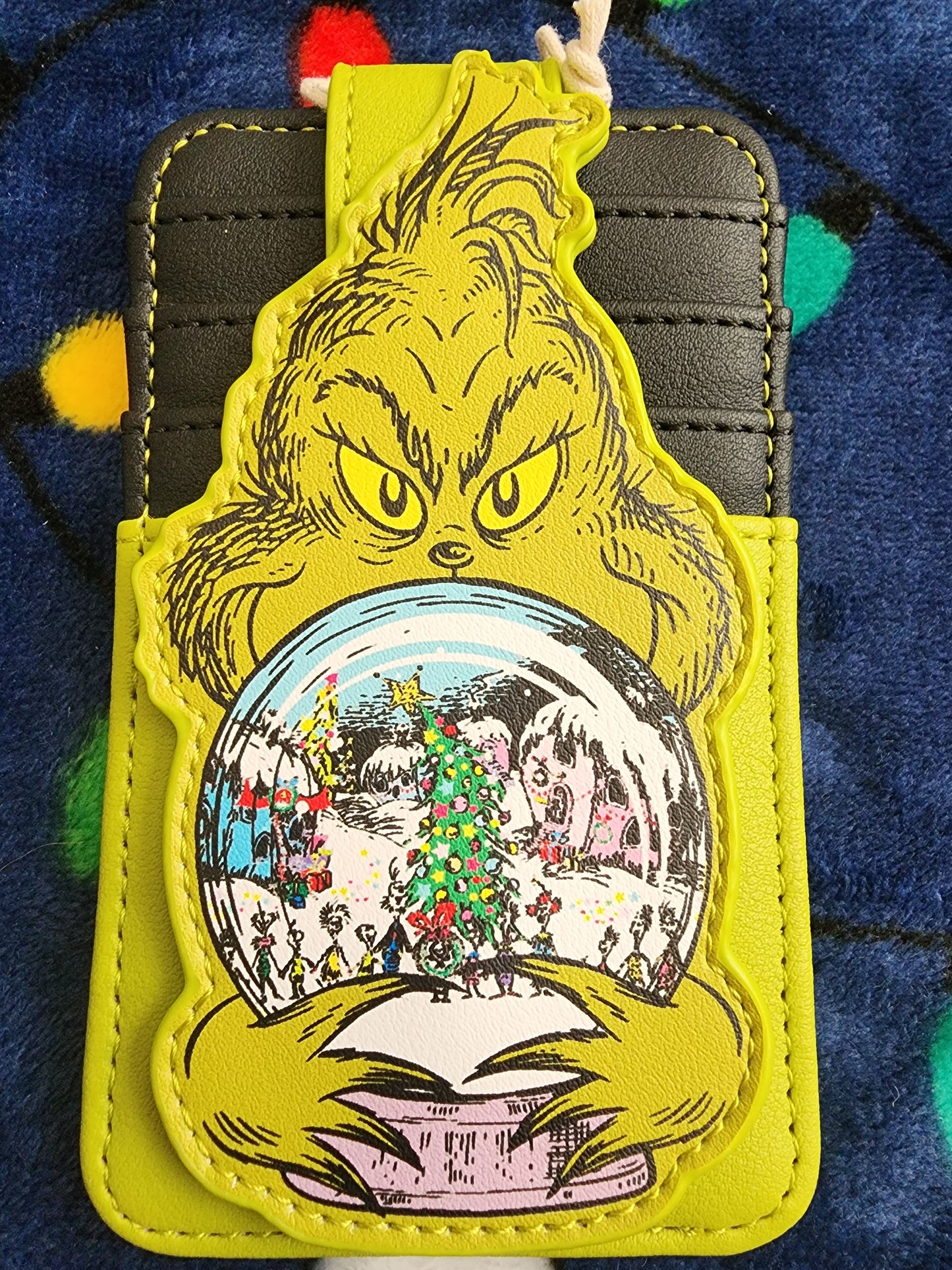 Loungefly The Grinch holding Whoville Snow Globe Snap Card Holder