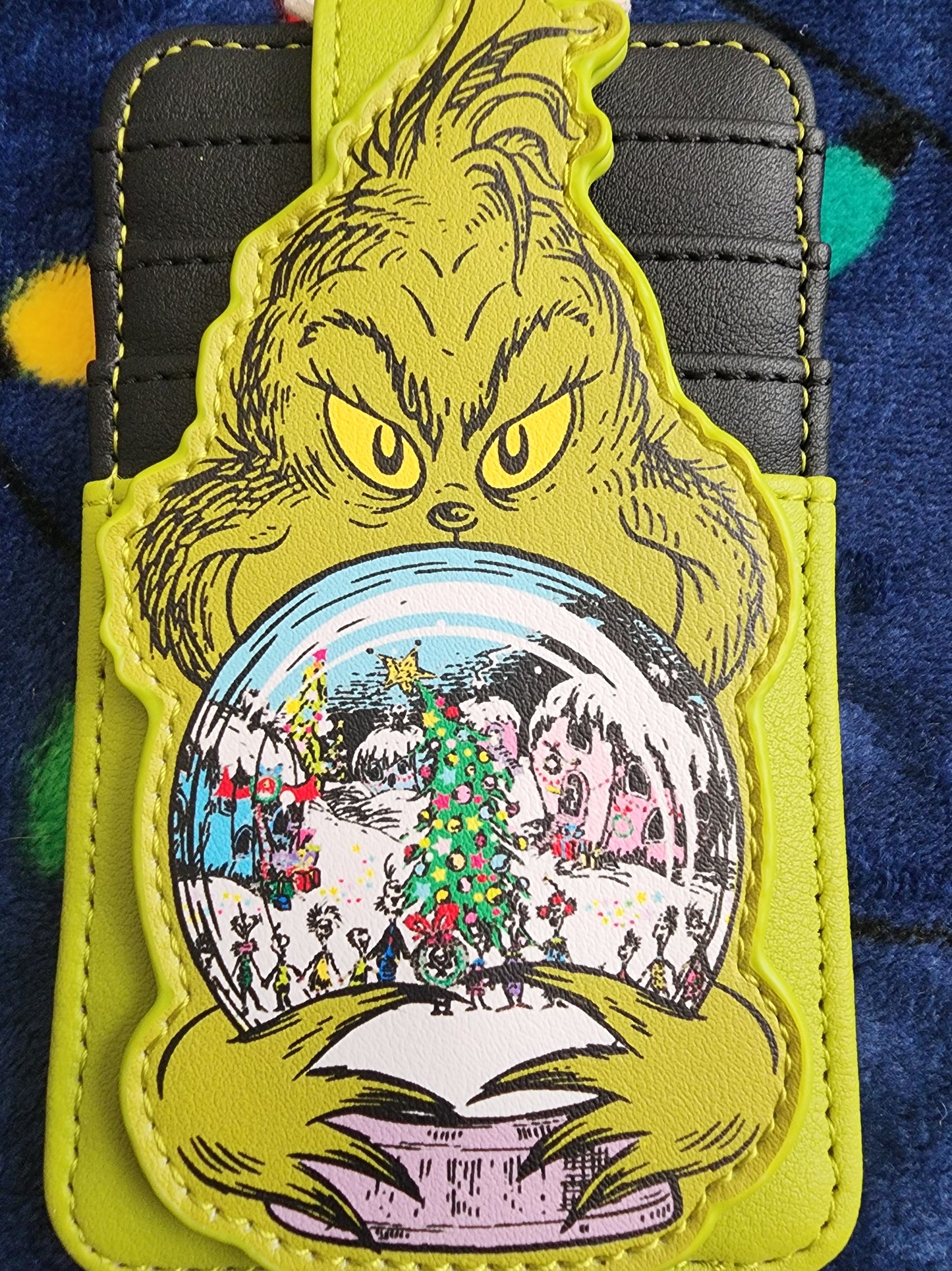 Loungefly The Grinch holding Whoville Snow Globe Snap Card Holder