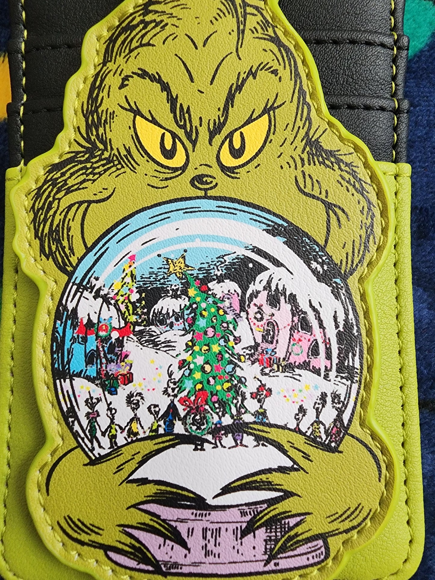 Loungefly The Grinch holding Whoville Snow Globe Snap Card Holder