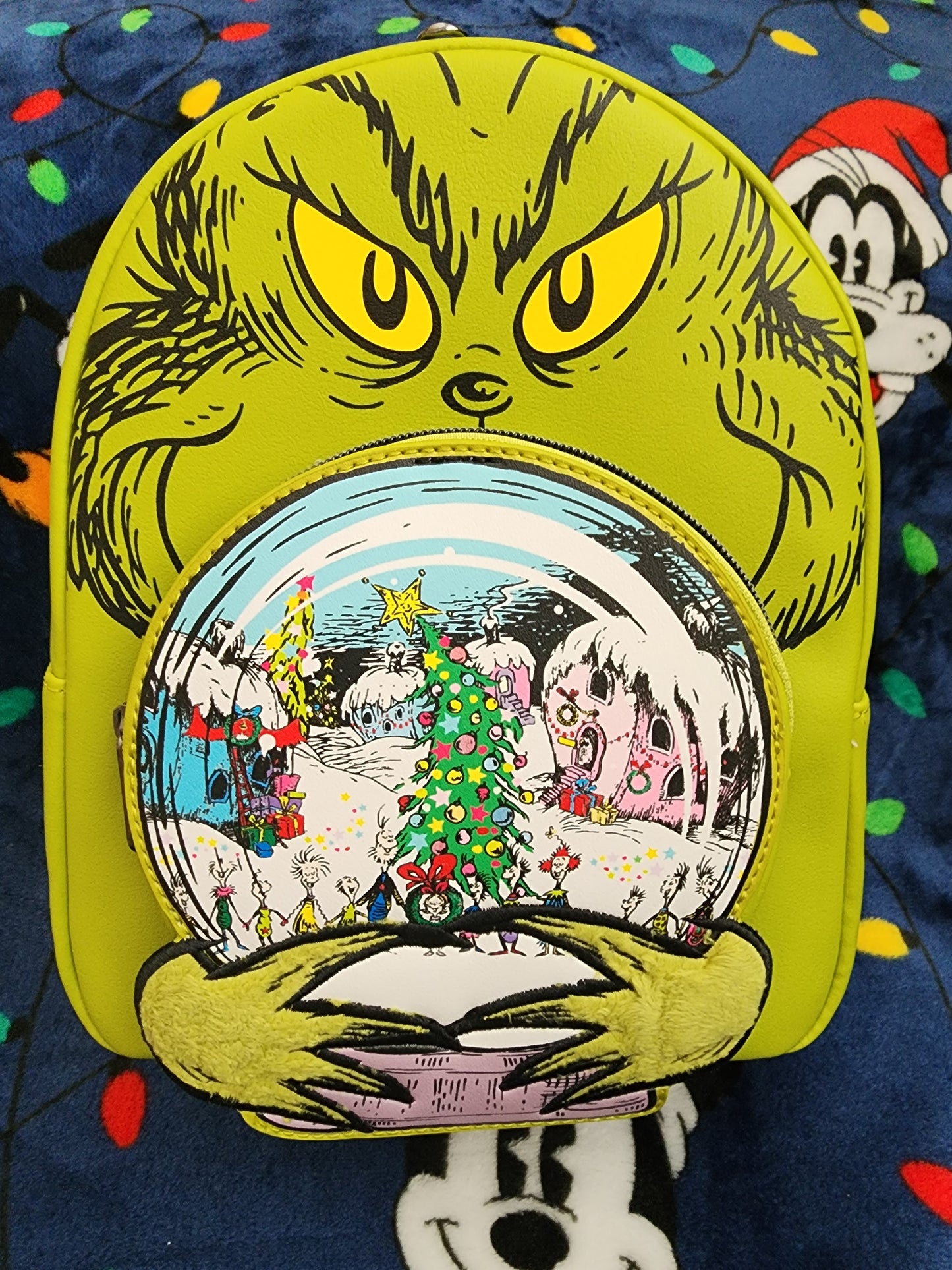 Loungefly The Grinch holding Whoville Snow Globe Backpack