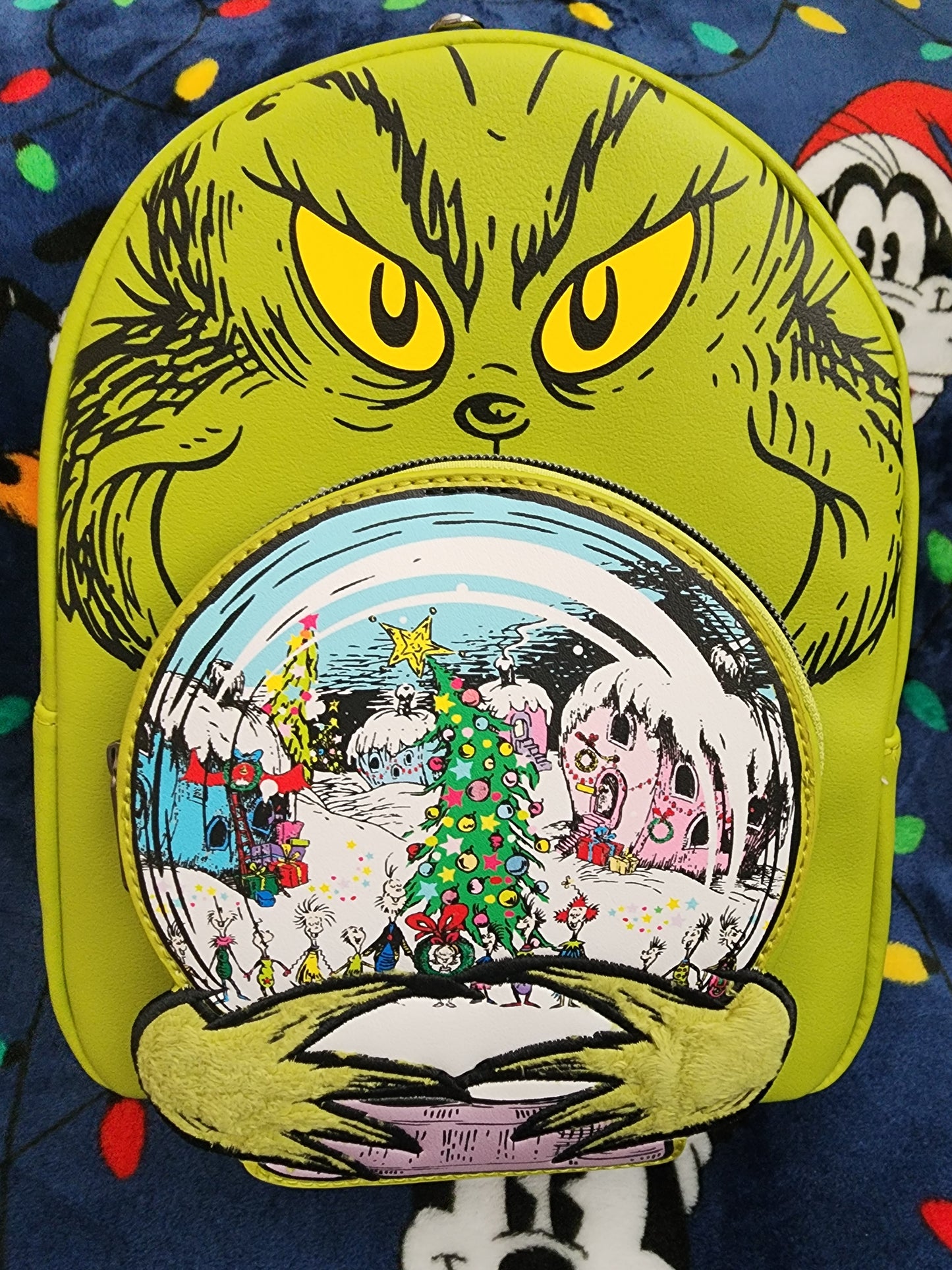 Loungefly The Grinch holding Whoville Snow Globe Backpack