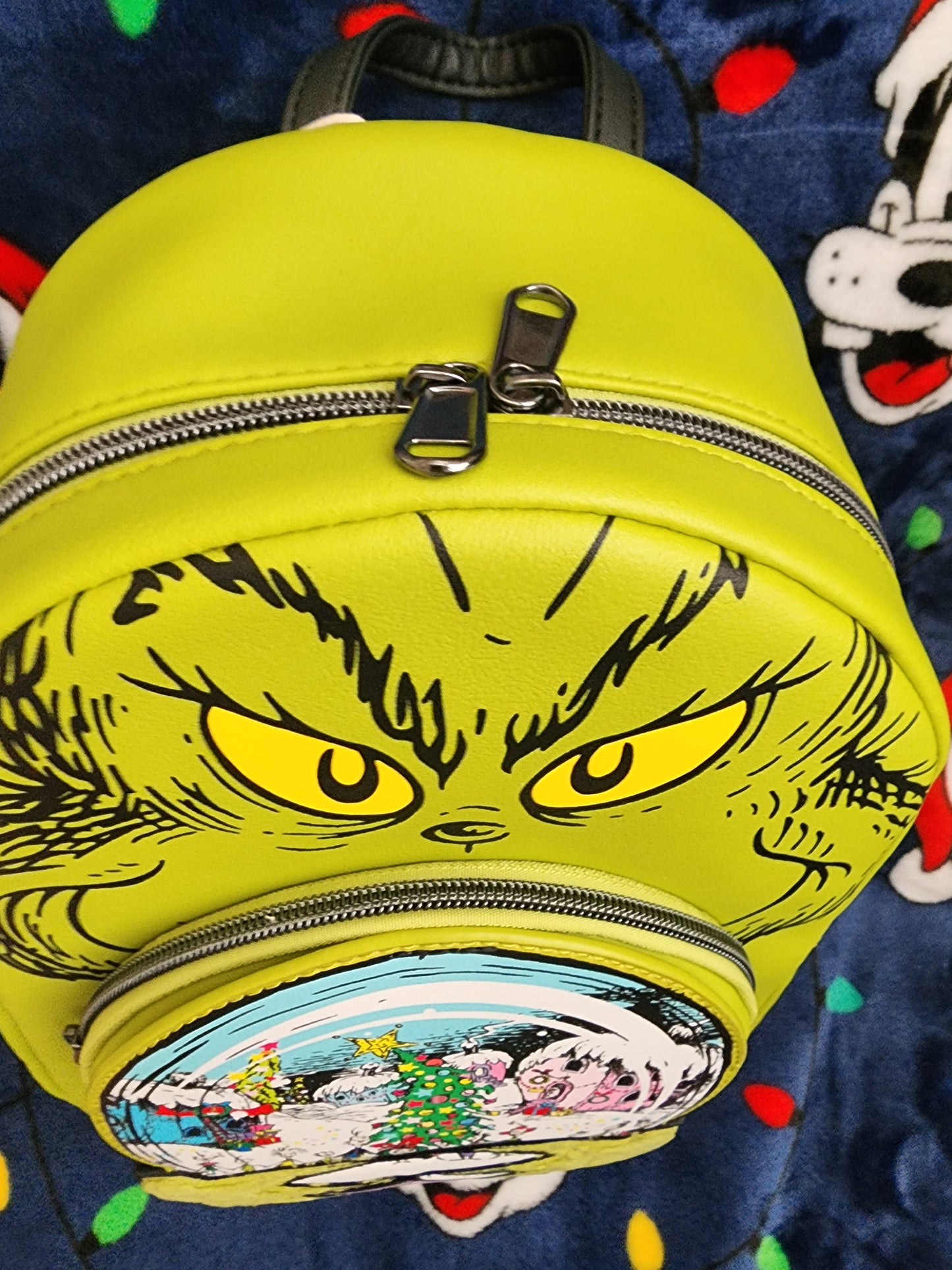 Loungefly The Grinch holding Whoville Snow Globe Backpack