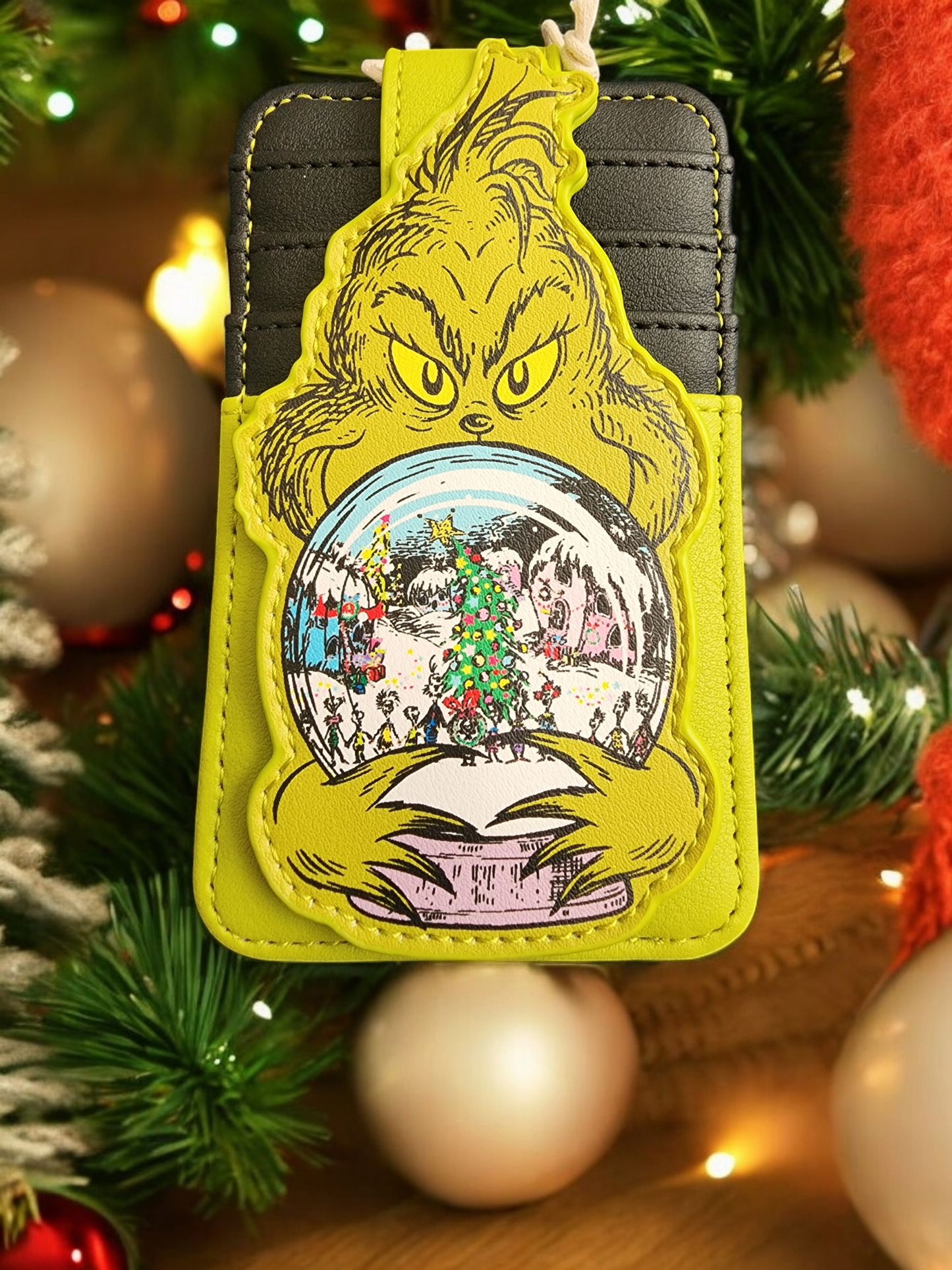 Loungefly The Grinch holding Whoville Snow Globe Snap Card Holder